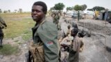 FILE - South Sudanese government soldiers stand in trenches in Malakal, South Sudan. 