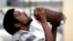 An Indian drinks water from a bottle on a hot summer day in Allahabad, India, Sunday, May 31, 2015.