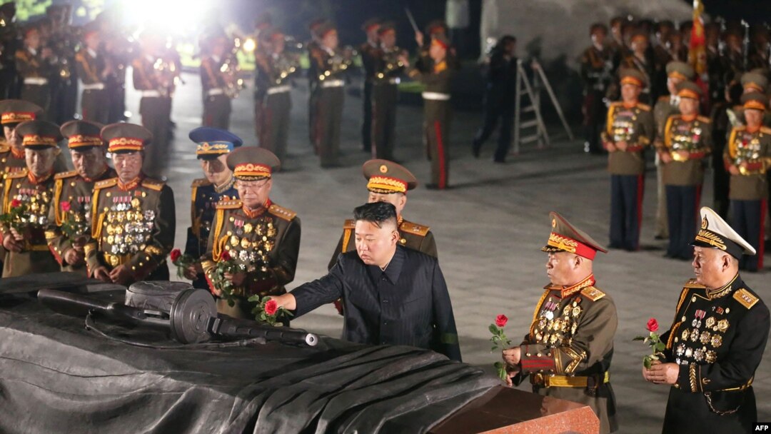 This picture taken early on July 27, 2021 and released from North Korea's official Korean Central News Agency (KCNA) shows North Korea's leader Kim Jong Un (C) visiting the Fatherland Liberation War Martyrs Cemetery in Pyongyang to mark the 68th anniversa
