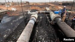 Oil engineers work on main oil pipeline before reopening operations, Heglig oilfield, Sudan, May 2, 2012.