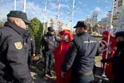 Police remove activists at the Cibeles fountain during a protest in Madrid, Spain, Dec. 3, 2019.