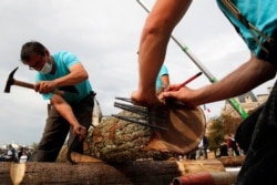 Carpenters put the skills of their medieval colleagues on show in front of Notre Dame Cathedral in Paris, France, Sept. 19, 2020. French President Emmanuel Macron wants the cathedral reopened in 2024 in time for the Paris Olympic Games.