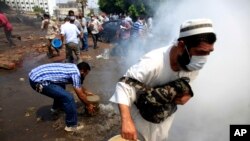 Supporters of Egypt's ousted President Mohammed Morsi clash with the Egyptian security forces as the forces clear their sit-in camp in the eastern Nasr City district of Cairo, Aug. 14, 2013.