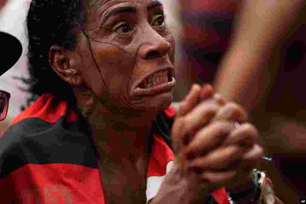 A fan of Brazil&#39;s Flamengo soccer team reacts after England&#39;s Liverpool scored a goal against the Brazilian team as she watches a live broadcast of the FIFA Club World Cup final soccer match, at the Rocinha slum in Rio de Janeiro, Brazil, Dec. 21, 2019.