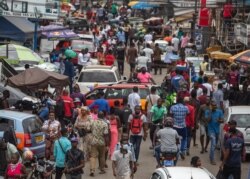 FILE - The crowd at the tiptoe lane, Kwame Nkrumah Circle in Accra, Ghana, is seen as the three-week-old partial lockdown to halt the spread of the coronavirus, is lifted, April 20, 2020.