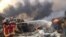 Firefighters spray water at a fire after an explosion was heard in Beirut, Lebanon Aug. 4, 2020. 