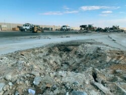 FILE - A crater is seen at al-Asad Air Base, in Anbar, Iraq, Jan. 13, 2020, following an Iranian missile attack.