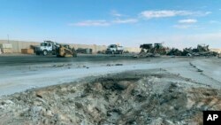 A crater is seen at Ain al-Asad air base, in Anbar, Iraq, Jan. 13, 2020, following an Iranian missile attack. The Pentagon now says 50 U.S. service members have been diagnosed with traumatic brain injury caused by the Jan. 8 attack.