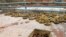 In this photo released by the Syrian official news agency SANA, landmines are collected by Syrian engineering troops from the M5 highway, recaptured by President Bashar Assad's forces this week, in Aleppo, Syria, Feb. 15, 2020.