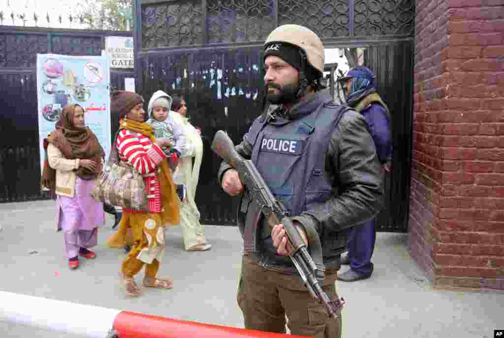A police commando stands guard outside a church during Christmas Mass in Lahore, Pakistan.