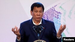 FILE - Philippines' President Rodrigo Duterte gestures during a news conference at the Association of South East Asian Nations (ASEAN) summit in Pasay, metro Manila, Philippines, Nov. 14, 2017.