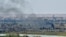 FILE - Smoke rises from the Islamic State (IS) group's last remaining position in the village of Baghuz during battles with the Syrian Democratic Forces (SDF), in the countryside of the eastern Syrian province of Deir el-Zour, March 20, 2019.