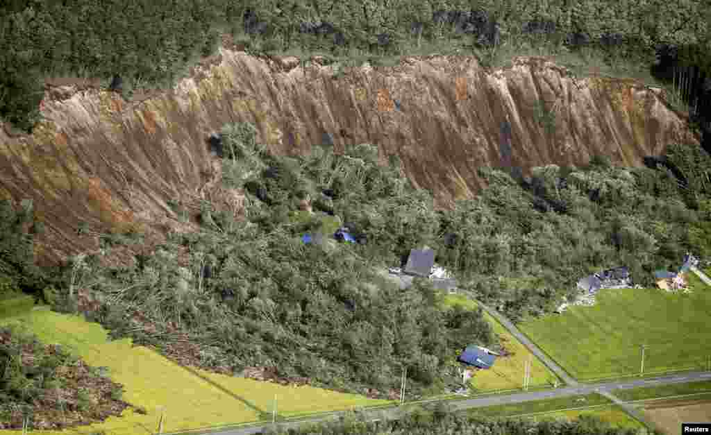 Houses damaged by a landslide caused by an earthquake are seen in Atsuma, a town in Japan&#39;s northern island of Hokkaido, Japan.