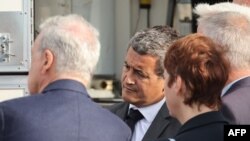 France's Minister of the Interior and Overseas, Gerald Darmanin speaks with officials as he arrives on a rescue site following the sinking of a migrant boat attempting to cross the English Channel to England in which twelve migrants have died, in Boulogne
