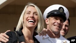 Navy Special Operations Chief Edward Gallagher, left, and his wife, Andrea Gallagher smile after leaving a military court on Naval Base San Diego, July 2, 2019, in San Diego.