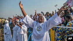 Worshipers greet Pope Francis as he arrives at Ndolo airport to celebrate Holy Mass, in Kinshasa, Congo, Feb. 1, 2023.