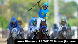 Victor Espinoza aboard American Pharoah celebrates their victory the 141st Kentucky Derby at Churchill Downs, May 2, 2015. (Credit: Jamie Rhodes-USA TODAY Sports)