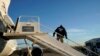 FILE - An Immigration and Customs Enforcement (ICE) officer awaits individuals to board a deporartion flight, in Houston, Texas, Nov. 16, 2018.