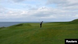 A golfer plays a shot on the Golfklubberinn Oddur golf course in Rekyavik June 5, 2013. About 10 percent of Iceland's population plays golf - a higher rate than the United States or Britain - making it the country's second most popular sport, after soccer.