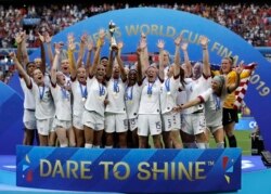 FILE - United States' team celebrates with trophy after winning the Women's World Cup final soccer match between US and The Netherlands at the Stade de Lyon in Decines, outside Lyon, France, July 7, 2019.
