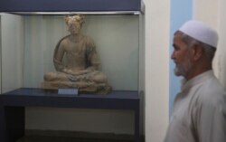 A complete figure of a seated Buddha dating from the third or fourth century is on display at the National Museum of Afghanistan in Kabul, Afghanistan, Aug. 17, 2019.