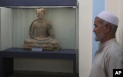 A complete figure of a seated Buddha dating from the third or fourth century is on display at the National Museum of Afghanistan in Kabul, Afghanistan, Aug. 17, 2019.