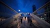 Workers cross the pedestrian bridge during rush hour from Bahrain Financial Harbour to downtown Manama, during the early evening hours in Manama, Bahrain, Nov.12, 2018.