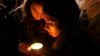 People light a candle for former president Nelson Mandela on hearing of his death outside his home in Johannesburg, South Africa, Dec. 5, 2013.