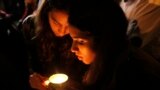 People light a candle for former president Nelson Mandela on hearing of his death outside his home in Johannesburg, South Africa, Dec. 5, 2013.