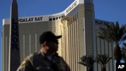 A Las Vegas police officer stands by a blocked-off area near the Mandalay Bay Resort and Casino, Oct. 3, 2017, in Las Vegas, which is near the site of the Oct. 1 mass shooting by Stephen Craig Paddock.