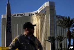A Las Vegas police officer stands by a blocked-off area near the Mandalay Bay Resort and Casino, Oct. 3, 2017, in Las Vegas, which is near the site of the Oct. 1 mass shooting by Stephen Craig Paddock.