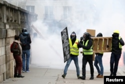 Protesters participate in a demonstration of the yellow vest movement in Nantes, France, Jan. 12, 2019.