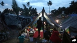 Villagers gather at a temporary shelter after fleeing their damaged village affected by Sunday's earthquake in North Lombok, Indonesia, Aug. 8, 2018. 