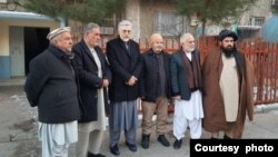 In this photo provided to VOA by Hasina Jalal, her father Faizullah Jalal, an Afghan professor (3rd from right), is seen with friends outside of his Kabul home on Jan. 11, 2022, after his release from a 4-day detention by the Taliban. (Courtesy photo) 