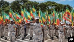 FILE: Members of the Ethiopian National Defense Force hold national flags as they parade during a ceremony to remember those soldiers who died on the first day of the Tigray conflict, outside the city administration office in Addis Ababa, Ethiopia Taken Nov. 3, 2022.
