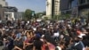 Women occupy a busy street intersection in Sandton, Johannesburg, during a protest against gender-based violence. (T. Khumalo/VOA)