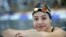 FILE - A Nov. 9, 2015 photo shows Yusra Mardini from Syria posing during a training session in Berlin, Germany. Mardini's family fled war and violence, crossing treacherous seas in small dinghies to live in dusty refugee camps.