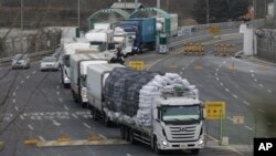 South Korean vehicles returning from North Korea's joint Kaesong Industrial Complex pass the customs, immigration and quarantine office near the border village of Panmunjom, in Paju, South Korea, Feb. 11, 2016.