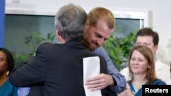 Kevin Brantly, (R) who contracted the deadly Ebola virus, hugs a member of Emory's medical staff during a press conference at Emory University Hospital in Atlanta, Georgia August 21, 2014. 