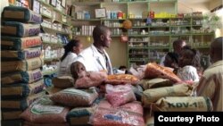 Farmers purchasing seed from an agro-dealer outlet. (Photo credit: Market Matters Inc.)