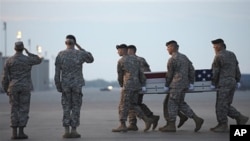 An Army carry team carries the transfer case containing the remains of Army Sgt. John Castro, of Andrews, Texas, at Dover Air Force Base, DE Saturday, April 23, 2011
