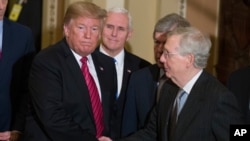 FILE - Then-President Donald Trump, left, shakes hands with then-Senate Majority Leader Mitch McConnell, as he departs, accompanied by then Vice President Mike Pence after a Senate Republican Policy luncheon, on Capitol Hill, in Washington, Jan. 9, 2019.