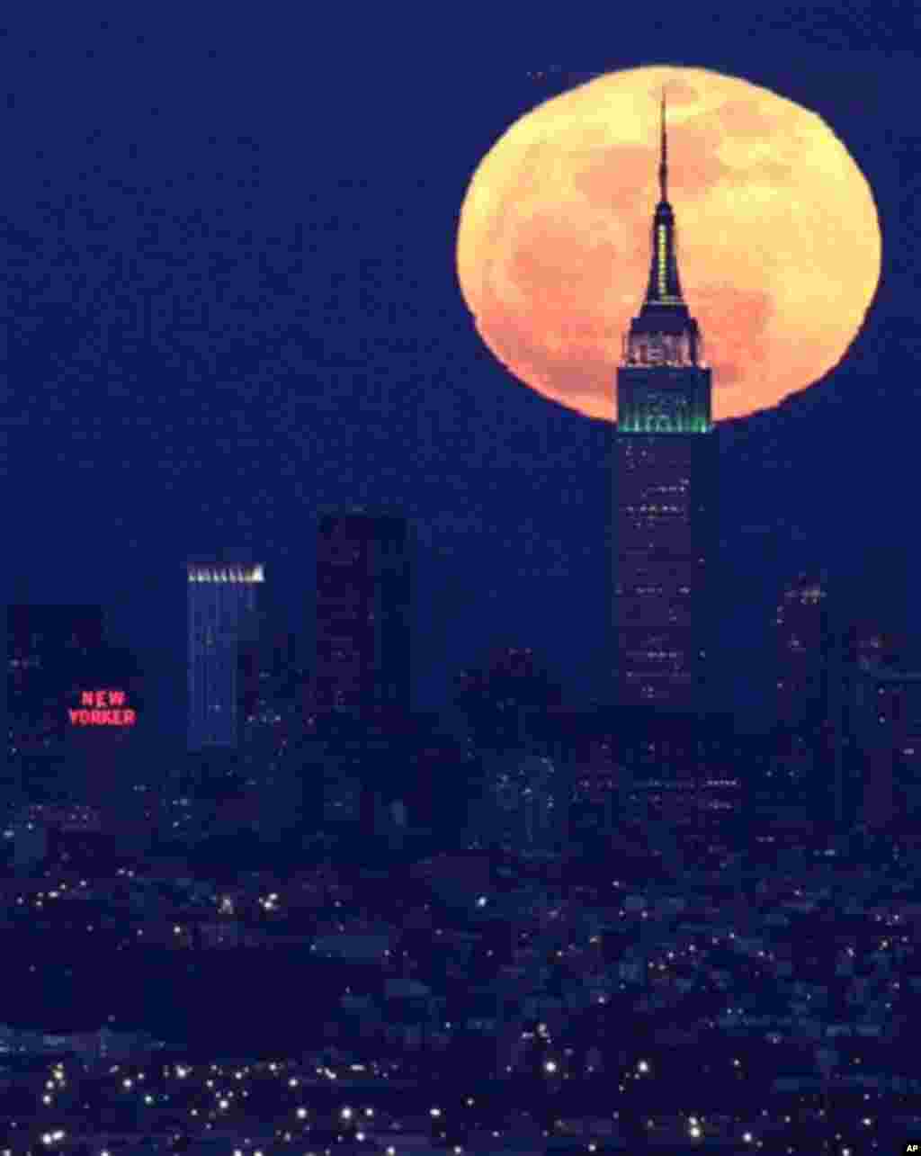 A full moon rises behind the Empire State Building in New York in this view from Eagle Rock Reservation in West Orange, N.J., on Friday, April 6, 2012. (AP Photo/Julio Cortez)