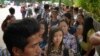 FILE - Myanmar citizens wait for their turn outside the Myanmar Embassy in Singapore to cast advance ballots in the country's Nov. 8 general election, Oct. 18, 2015. 