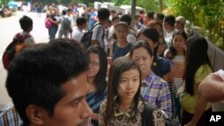 FILE - Myanmar citizens wait for their turn outside the Myanmar Embassy in Singapore to cast advance ballots in the country's Nov. 8 general election, Oct. 18, 2015. 