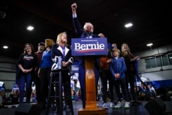 Democratic presidential candidate Sen. Bernie Sanders, I-Vt., accompanied by his wife and other family members speaks during a primary night election rally in Essex Junction, Vt., March 3, 2020.