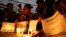 Activists hold candles in front of the picture of murdered 17-year-old student Kian Loyd delos Santos in Caloocan, metropolitan Manila, Philippines on Nov. 29, 2018. 