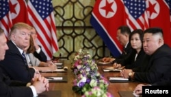 North Korea's leader Kim Jong Un and U.S. President Donald Trump look on during the extended bilateral meeting in the Metropole hotel during the second North Korea-U.S. summit in Hanoi, Vietnam, Feb. 28, 2019. 