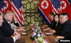 North Korea's leader Kim Jong Un and U.S. President Donald Trump look on during the extended bilateral meeting in the Metropole hotel during the second North Korea-U.S. summit in Hanoi, Vietnam, Feb. 28, 2019.