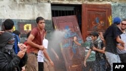 Egyptian students of al-Azhar University block the access to an administration building during an anti-army protest on October 30, 2013 at the university in Cairo.